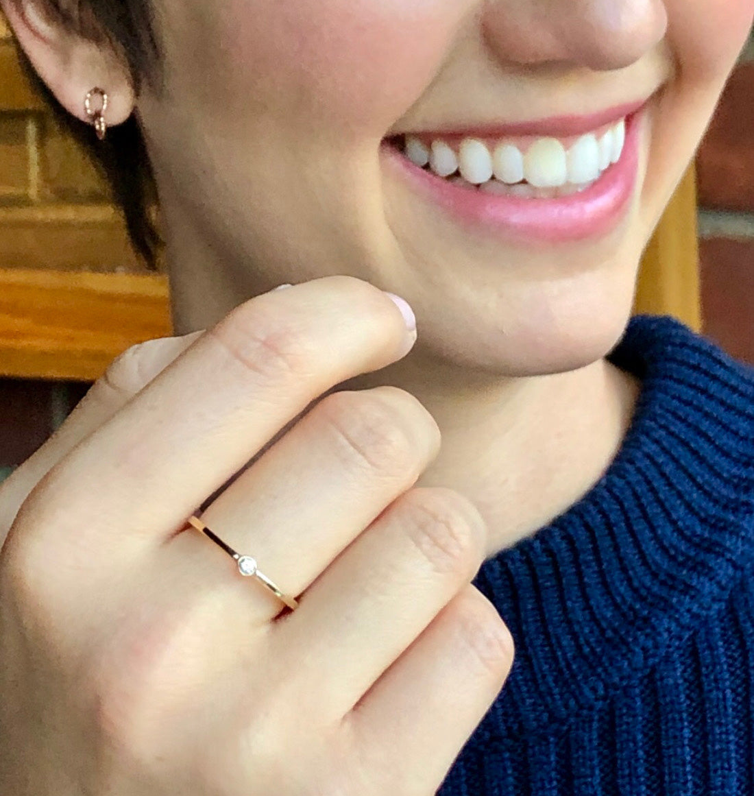 bizel mini band in gold in a models hand