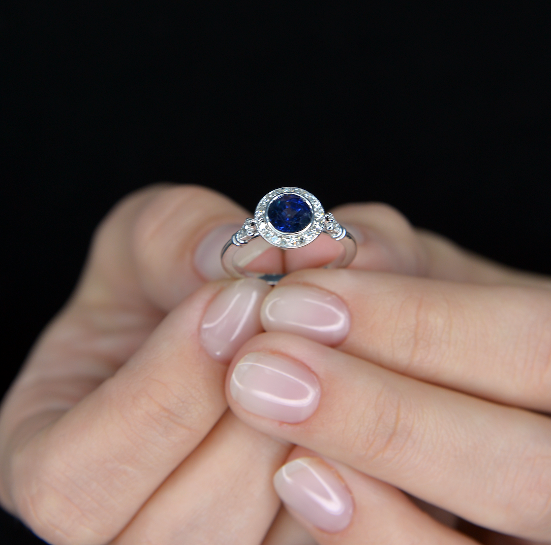 blue sapphire vintage engagement ring in white gold pink background