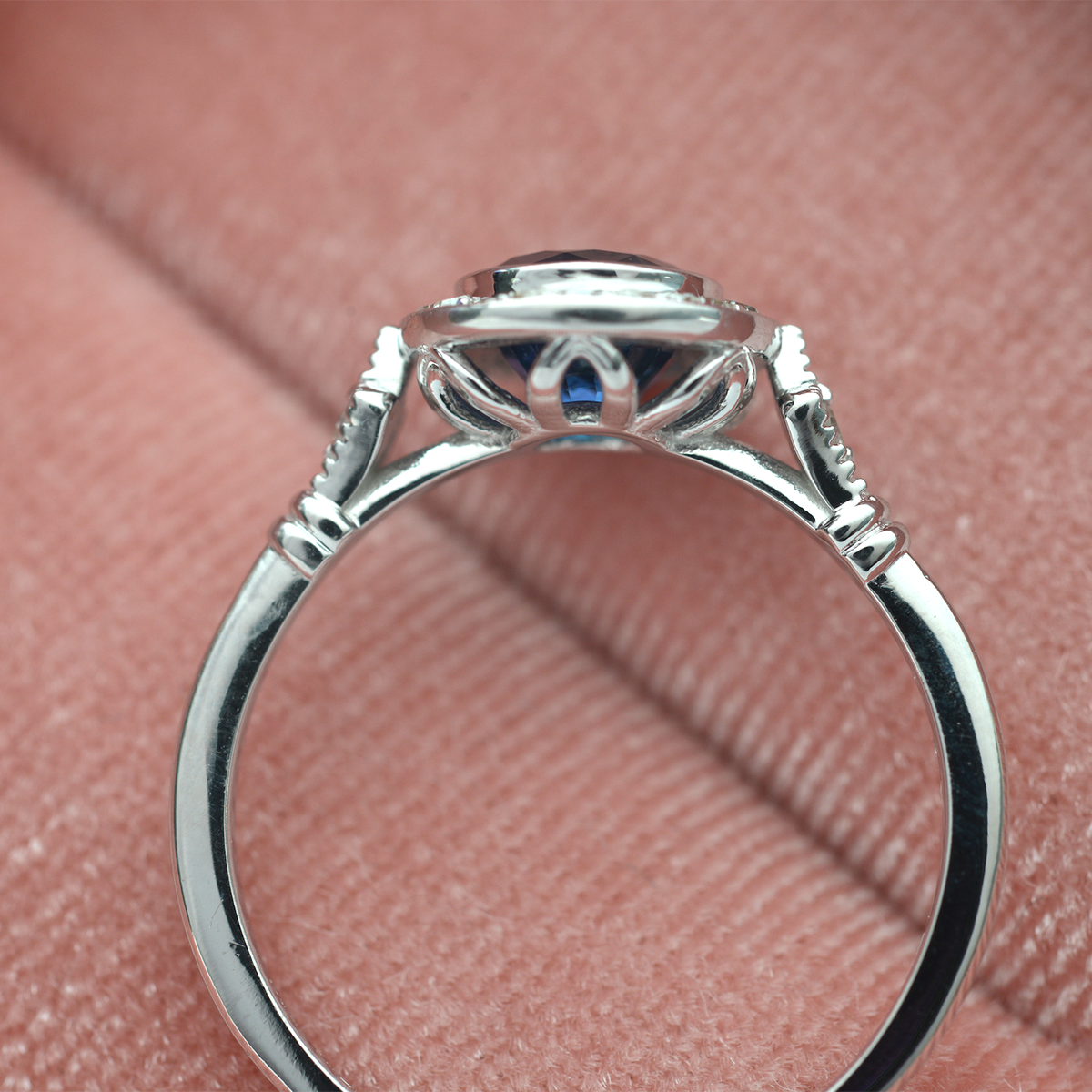 blue sapphire vintage engagement ring in white gold pink background