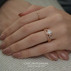 Rose gold engagement ring vintage inspired halo with a twist band  in a hand
