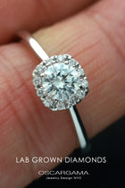 engagement ring with a cushion halo in white gold  in a finger