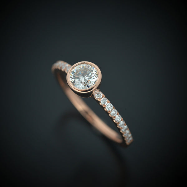 round bezel style engagement ring with pave in rose gold