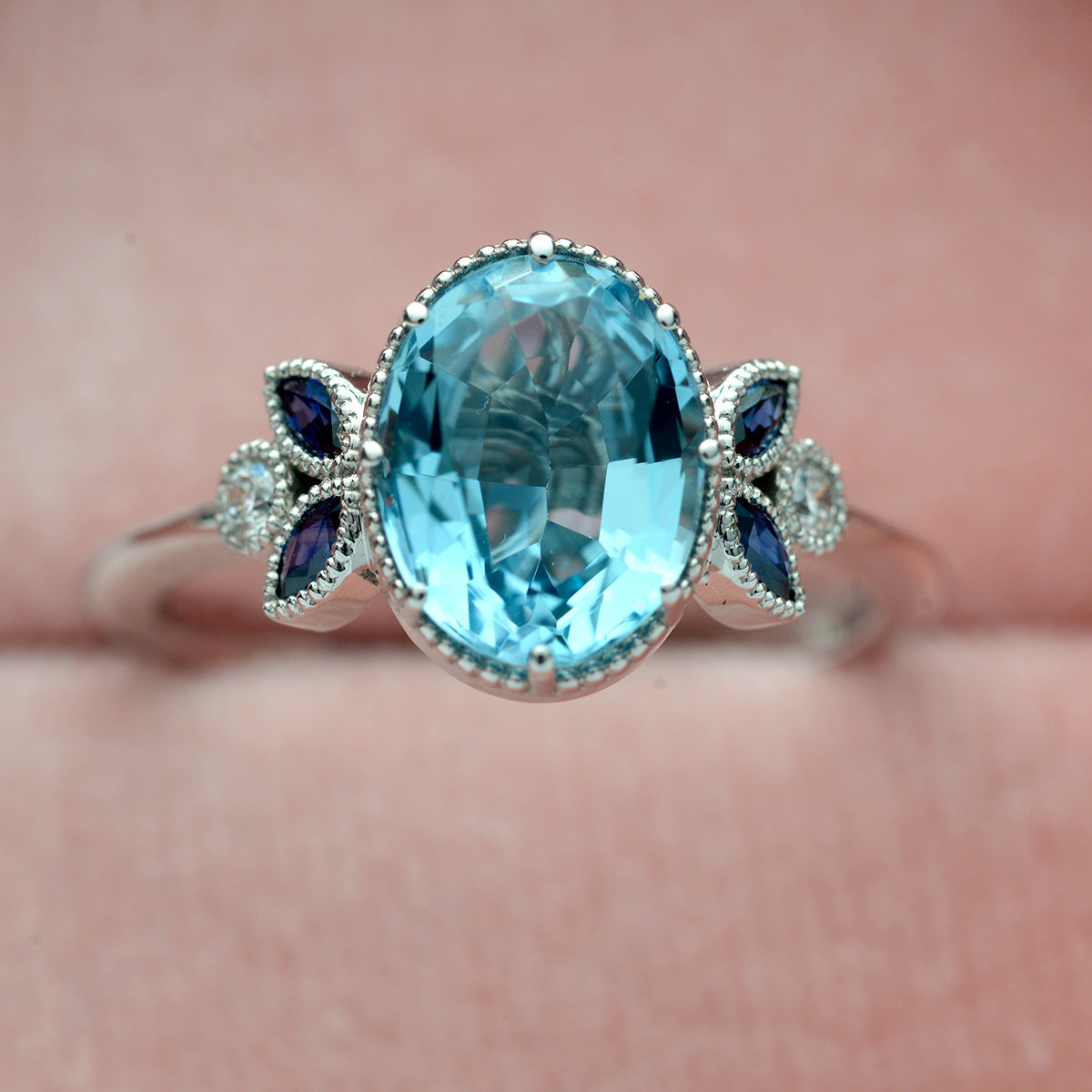 Oval blue aqua marine engagement ring with marquise sapphires