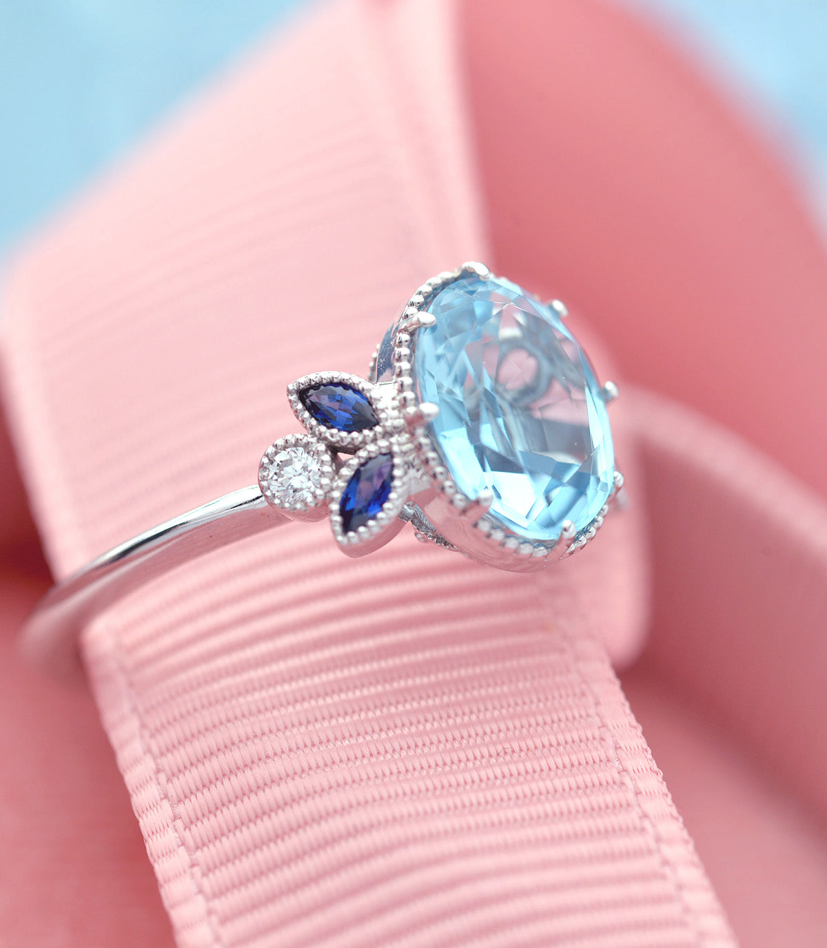 Oval blue aqua marine engagement ring with marquise sapphires