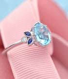 Oval blue aqua marine engagement ring with marquise sapphires