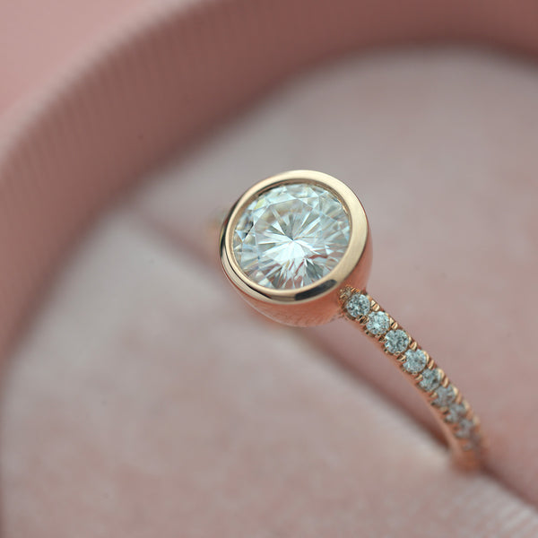 round bezel style engagement ring with pave in rose gold