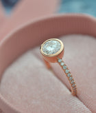 round bezel style engagement ring with pave in rose gold