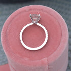 Diamond solitaire engagement ring 2ct on top of a pink box