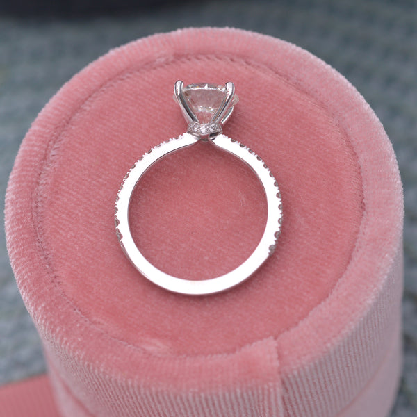 Diamond solitaire engagement ring 2ct on top of a pink box