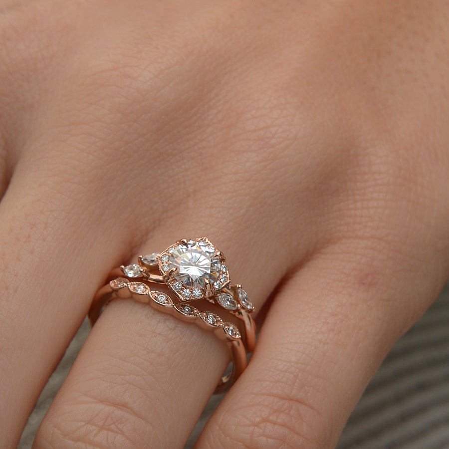 Rose gold engagement ring vintage inspired halo with a twist band  in a hand