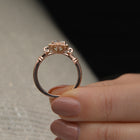 Oval Halo vintage look engagement ring in a hand