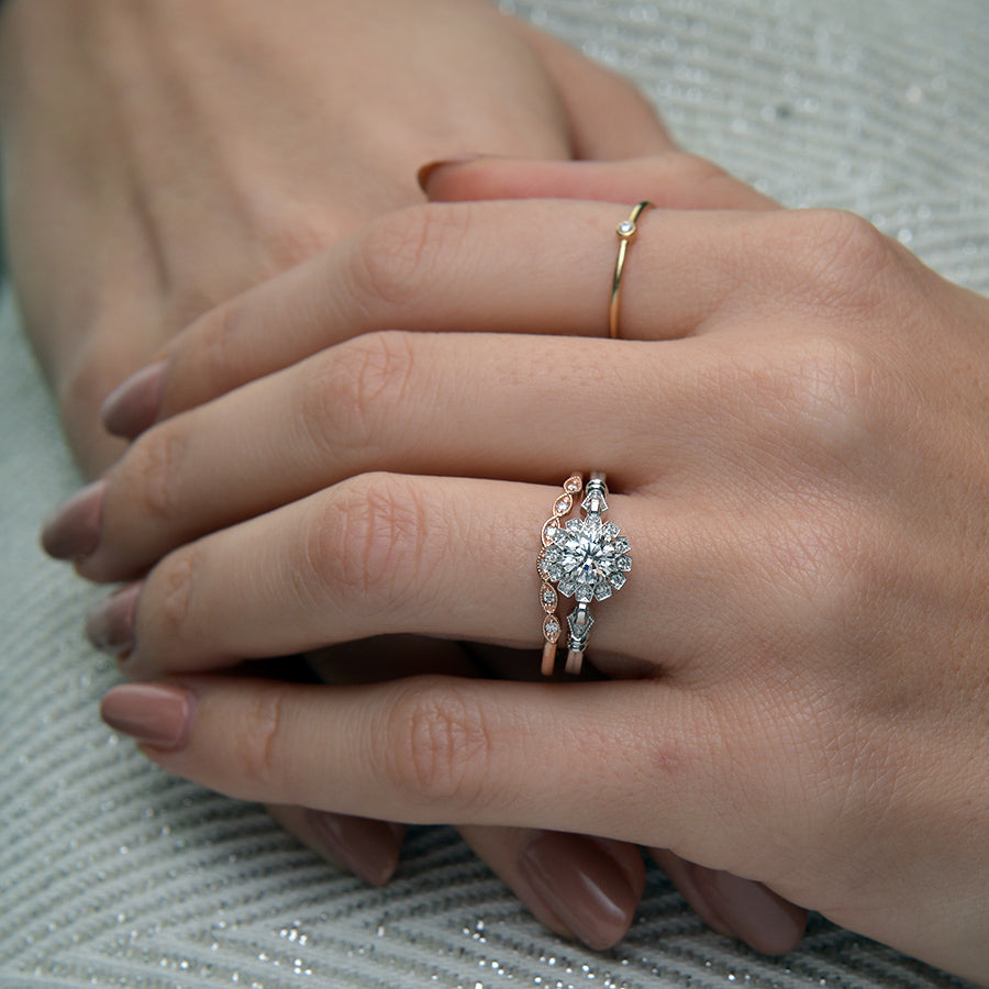 round halo vintage inspired engagement ring in rose gold in a finger