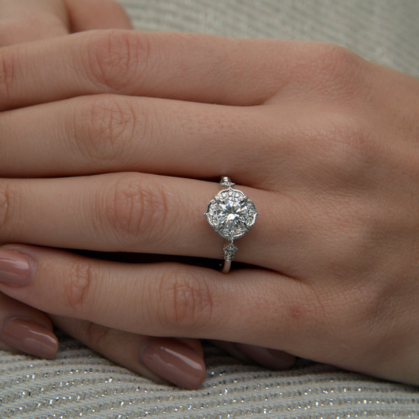Lyzzy vintage inspired round engagement ring in white gold on a hand