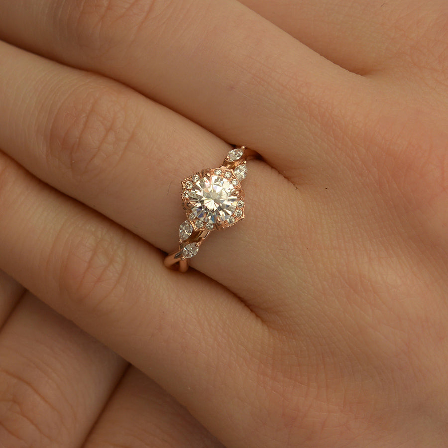 Rose gold engagement ring vintage inspired halo with a twist band  in a hand