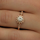 round halo vintage inspired engagement ring in rose gold  in a finger