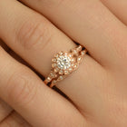 round halo vintage inspired engagement ring in rose gold  in a hand