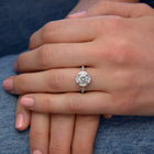 Lyzzy vintage inspired round engagement ring in white gold in a hand