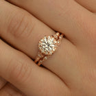 rose gold cushion halo engagement ring in a hand