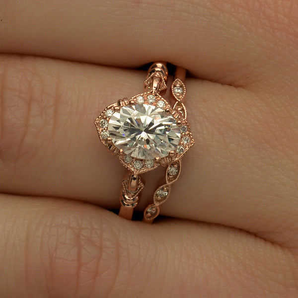 Oval Halo vintage look engagement ring with band shown in a hand