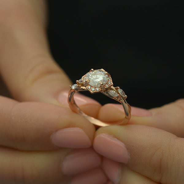 Rose gold engagement ring vintage inspired halo with a twist band  in a hand