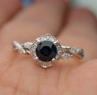 white gold blue sapphire halo engagement ring twisted band