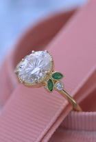 Oval engagement ring with marquise emeralds in yellow gold vintage inspired