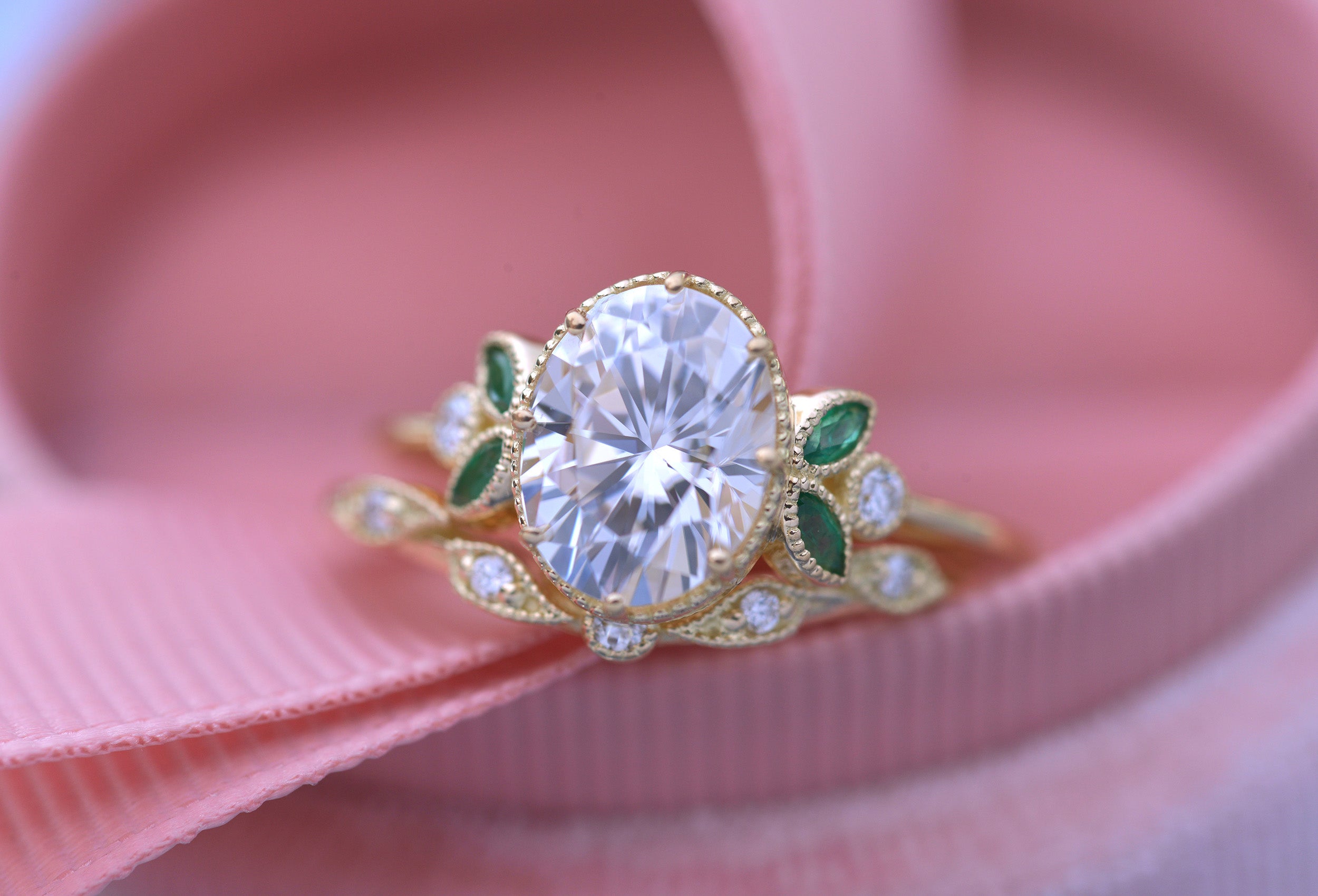 Oval engagement ring with marquise emeralds in yellow gold vintage inspired