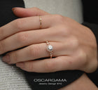 round halo vintage inspired engagement ring in rose gold  in a hand