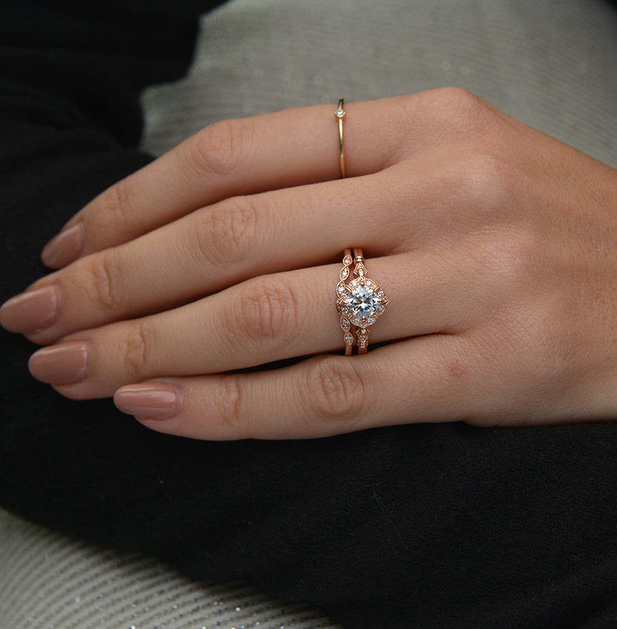 vintage cushion halo engagement ring in rose gold in models hand