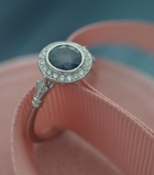 blue sapphire vintage engagement ring in white gold pink background