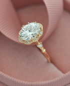 Vintage oval halo engagement ring in yellow gold