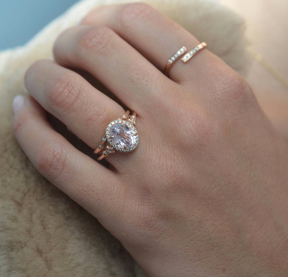 Oval pink Morganite engagement ring halo in rose gold in model hand