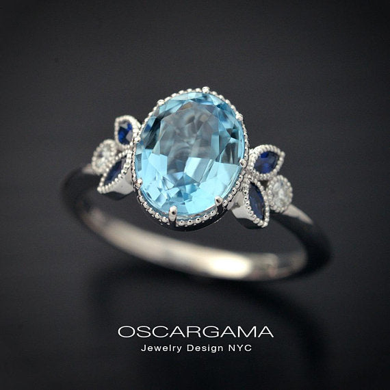 Oval blue aqua marine engagement ring with marquise sapphires