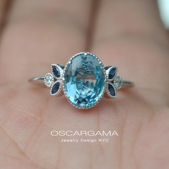 Oval blue aqua marine engagement ring with marquise sapphires