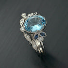 Oval blue aqua marine engagement ring with marquise sapphires