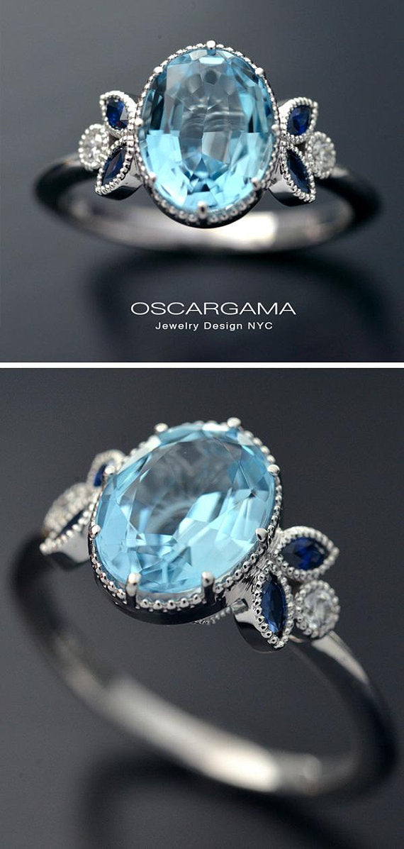 Oval blue aqua marine engagement ring with marquise sapphires