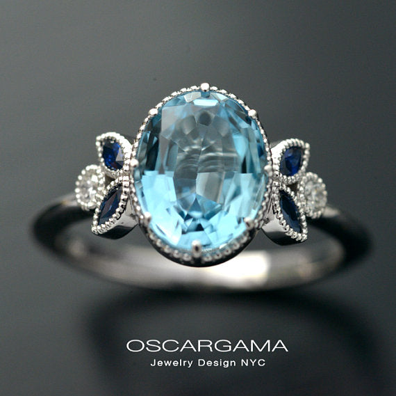 Oval blue aqua marine engagement ring with marquise sapphires