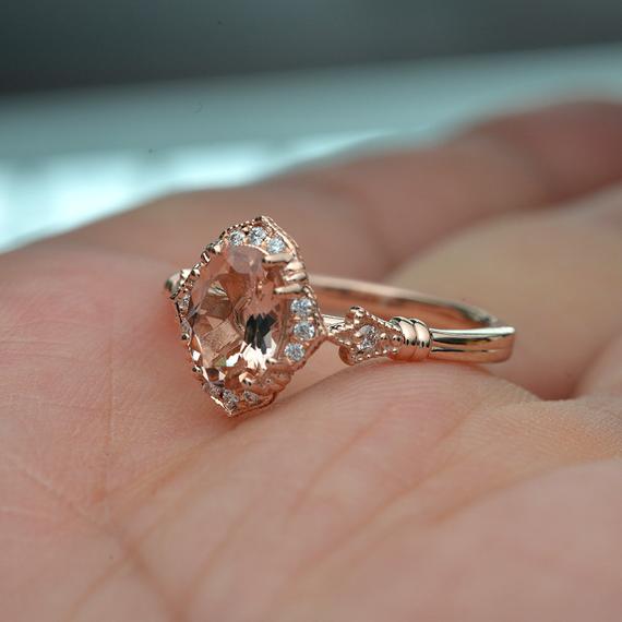 oval halo engagement ring vintage inspired with a morganite in rose gold in a hand