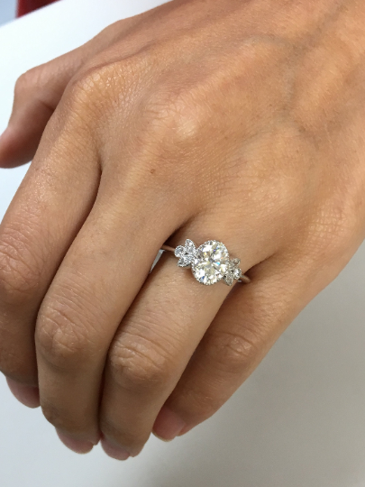 Oval Engagement Ring Vintage Inspired with marquises in a hand